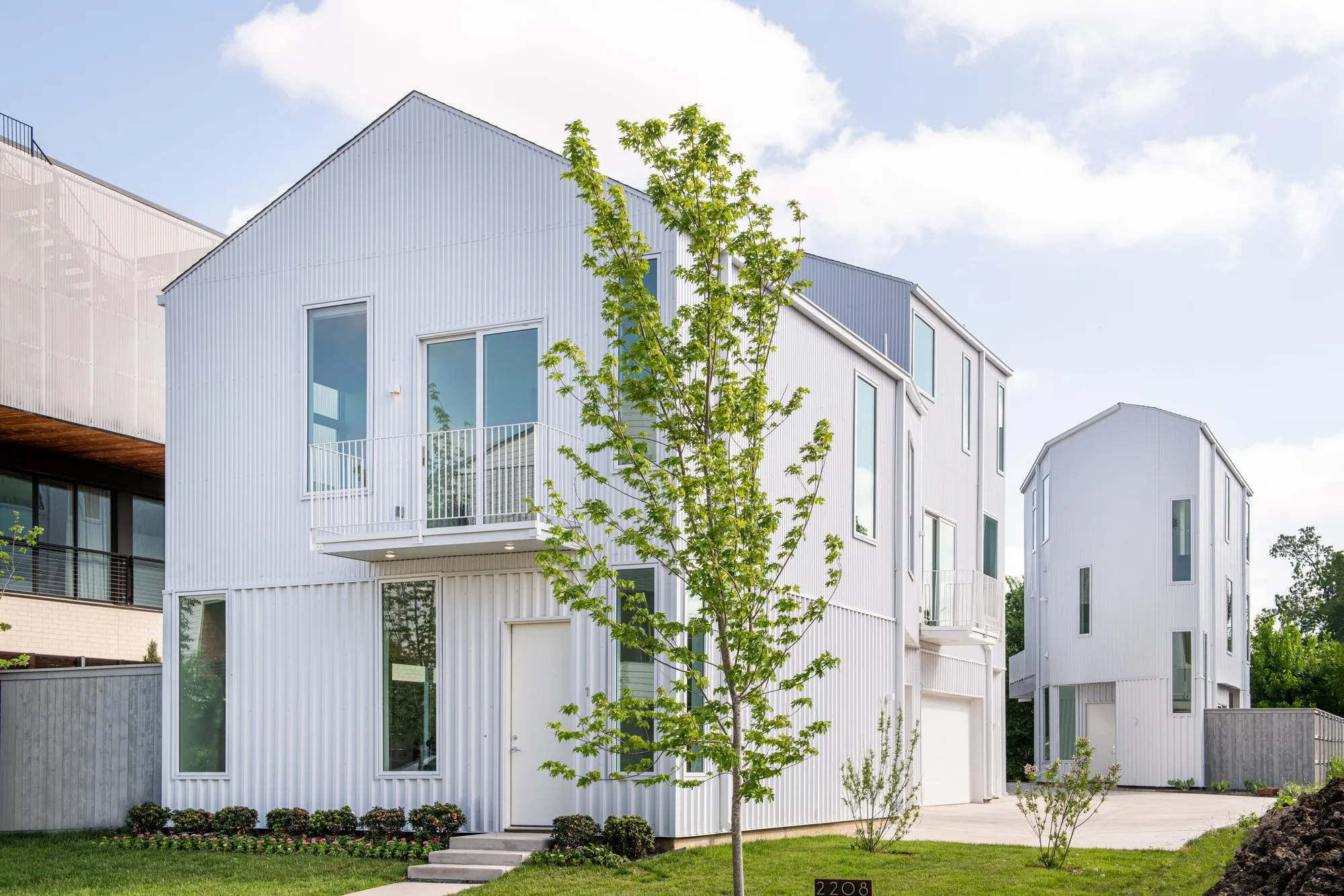 2208 Moser Avenue: white gabled front with a balcony