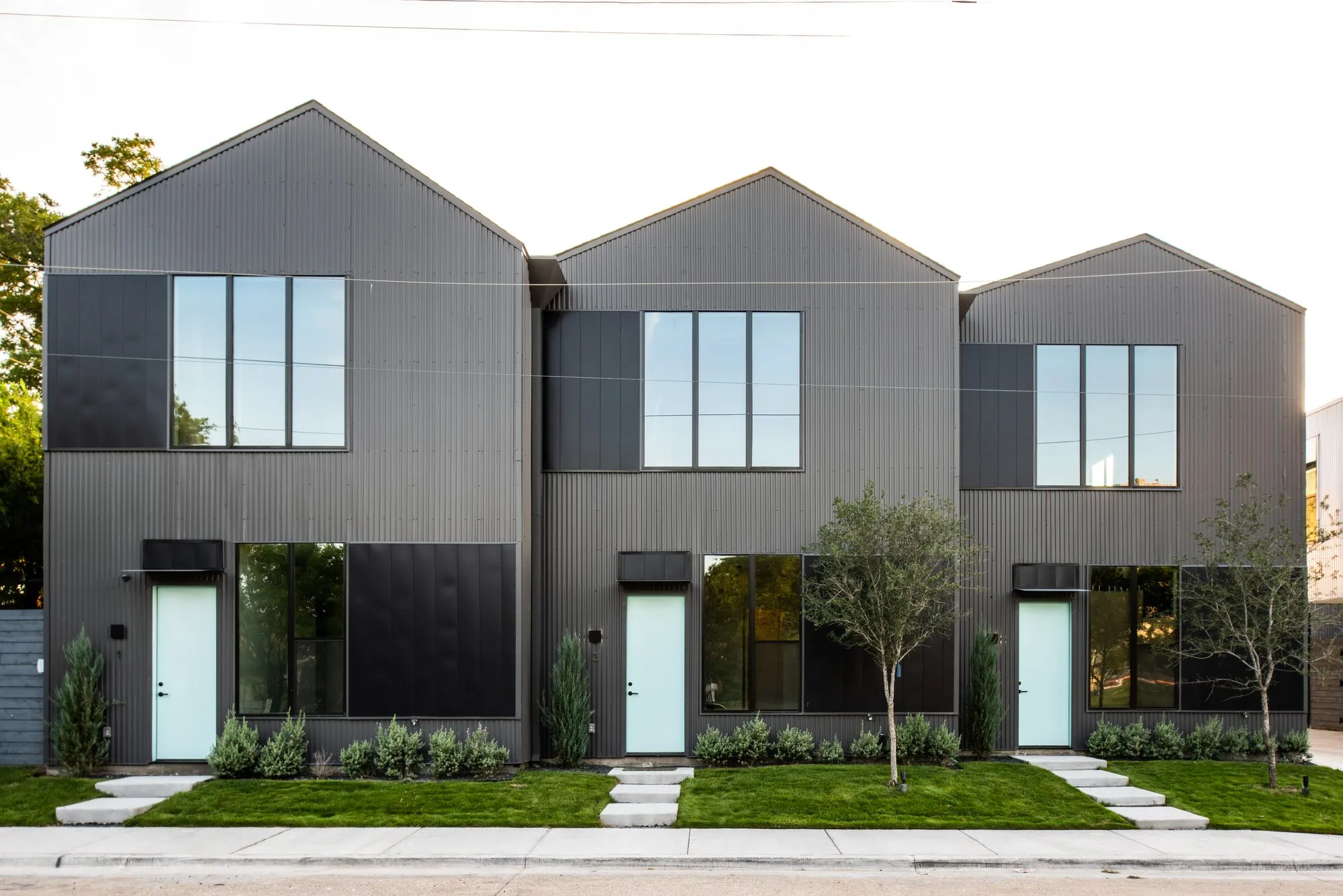 4401 Scurry Street: three dark gabled townhomes in daylight