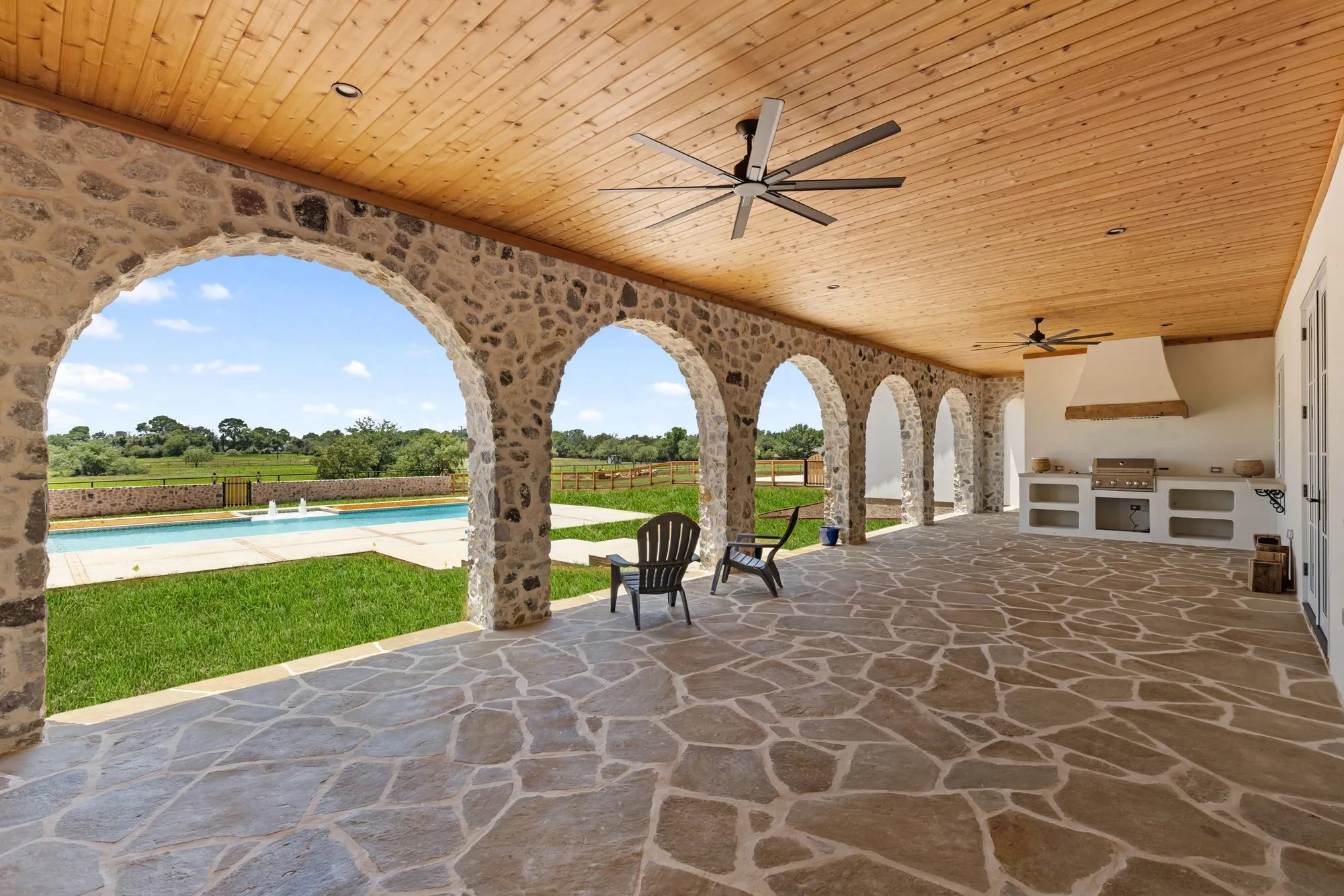 721 Eagles Landing: arched stone loggia looking toward the pool