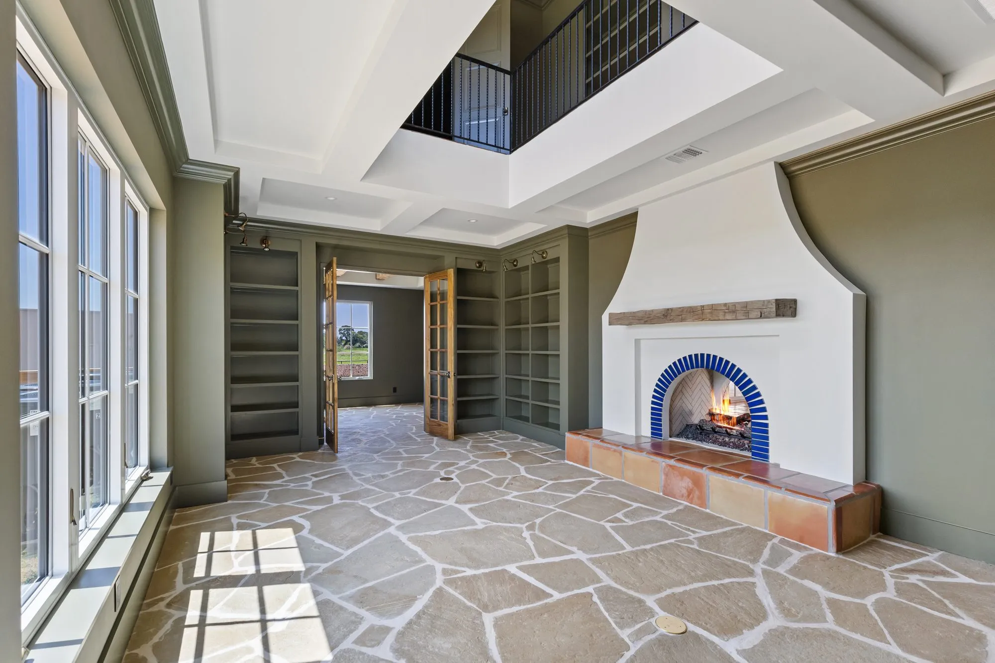 721 Eagles Landing: fireplace with a blue tile surround and stone floors