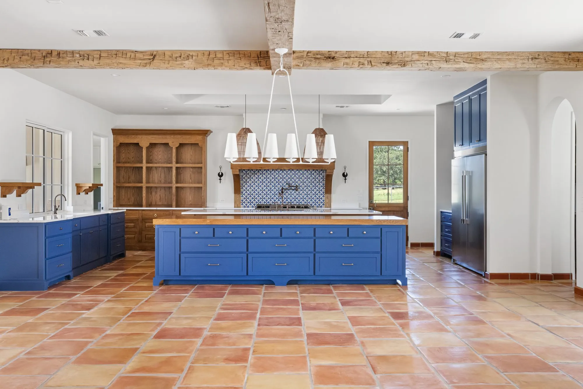721 Eagles Landing: kitchen with a blue island and a wood range hood