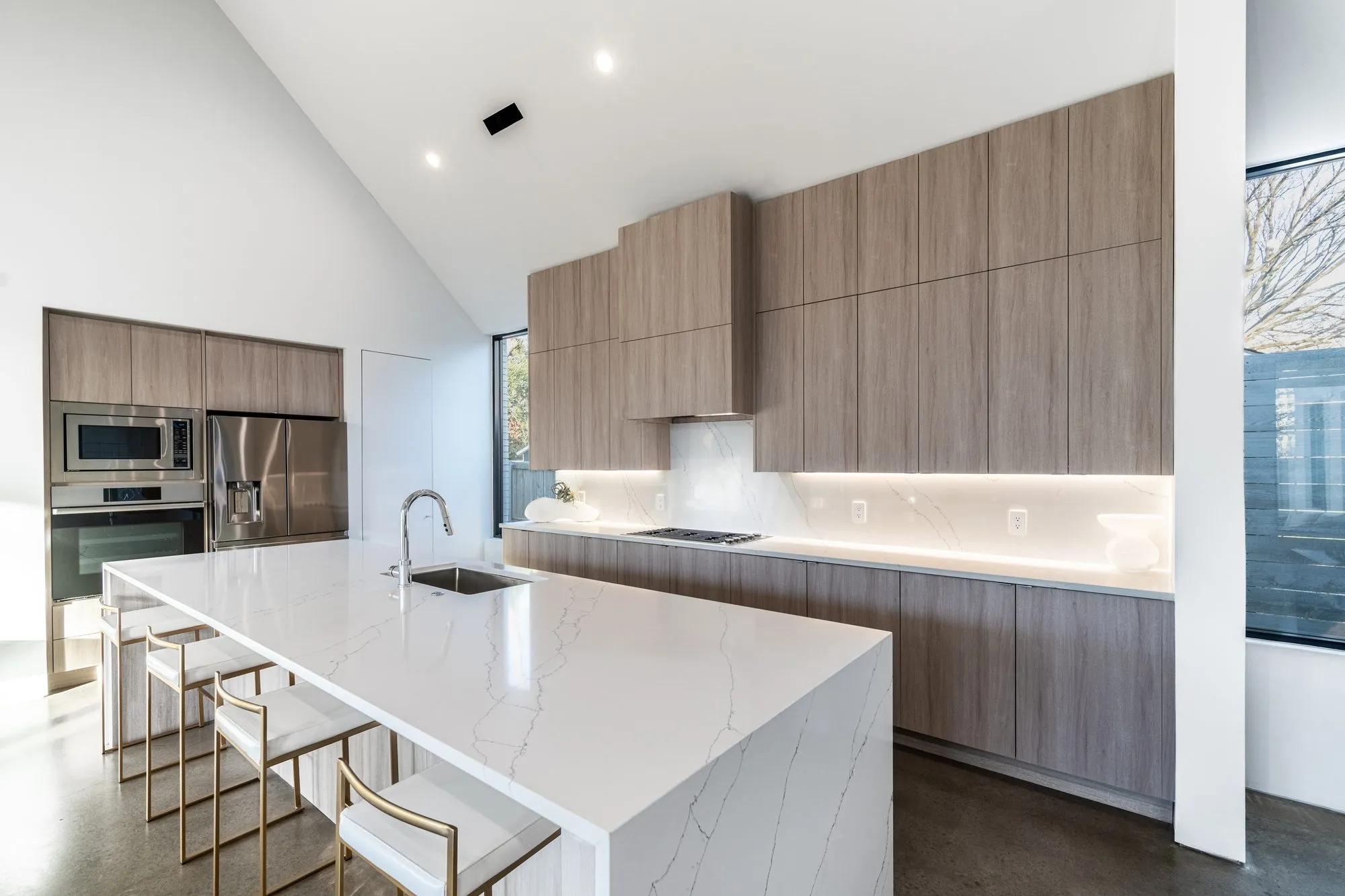 3805 Eaton Drive: kitchen with a white waterfall island and wood cabinets