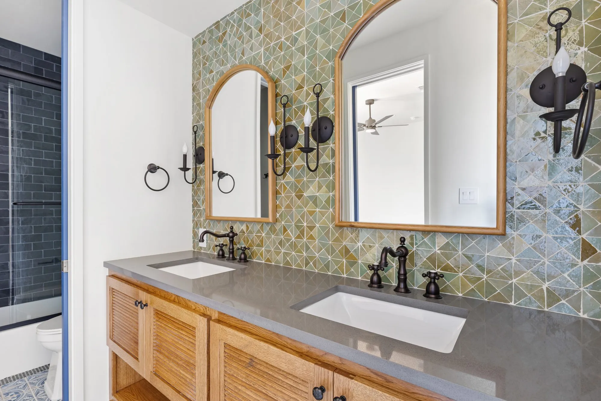 721 Eagles Landing: double vanity with a green tile wall