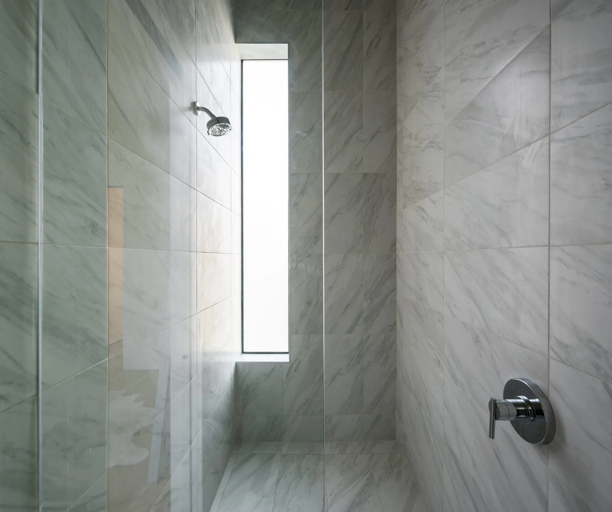 4401 Scurry Street: tiled shower with a tall window