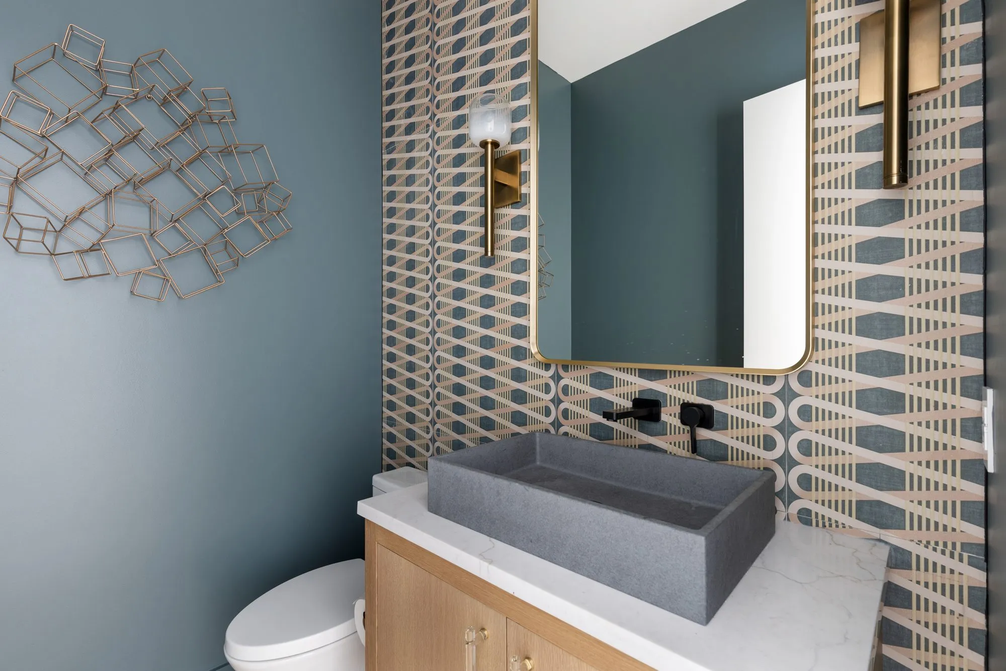 3880 Durango: powder room with a stone vessel sink and patterned wall