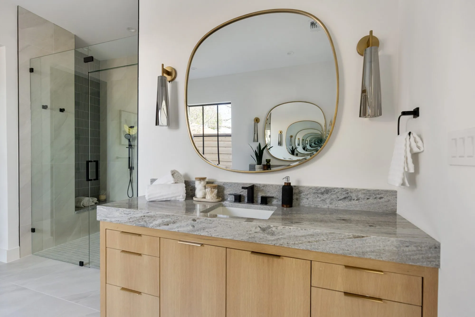 3880 Durango: bath vanity with an oval mirror and a glass shower