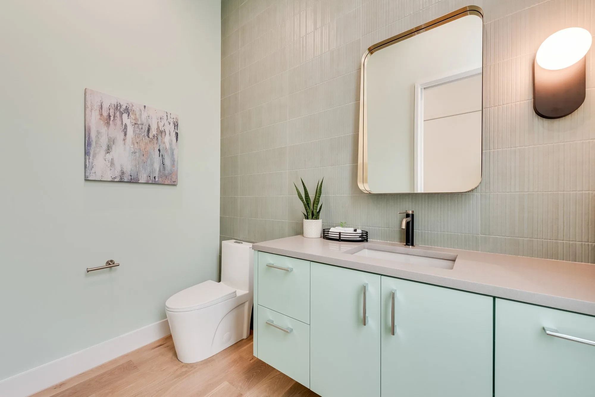 4103 Saranac: bath with a pale green vanity and a green tile wall