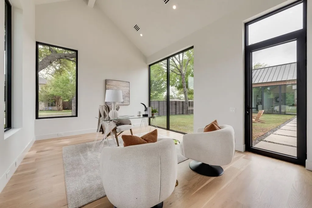 4103 Saranac: office with a vaulted ceiling, a glass desk and a glass door to the courtyard
