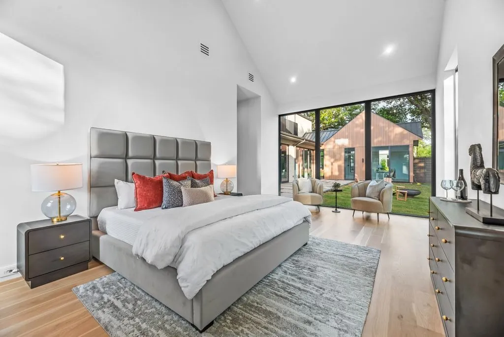 4103 Saranac: bedroom with a vaulted ceiling and a glass wall onto the courtyard