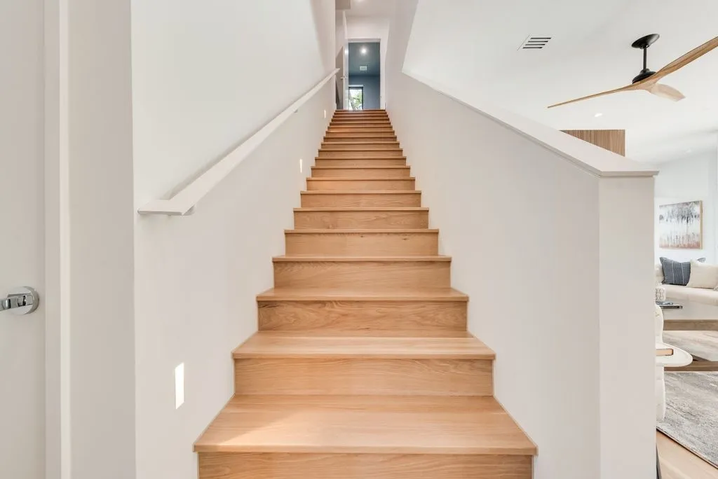 Wood staircase beside the living room