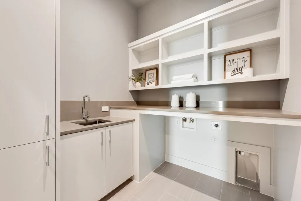 Laundry room with a sink and open shelves